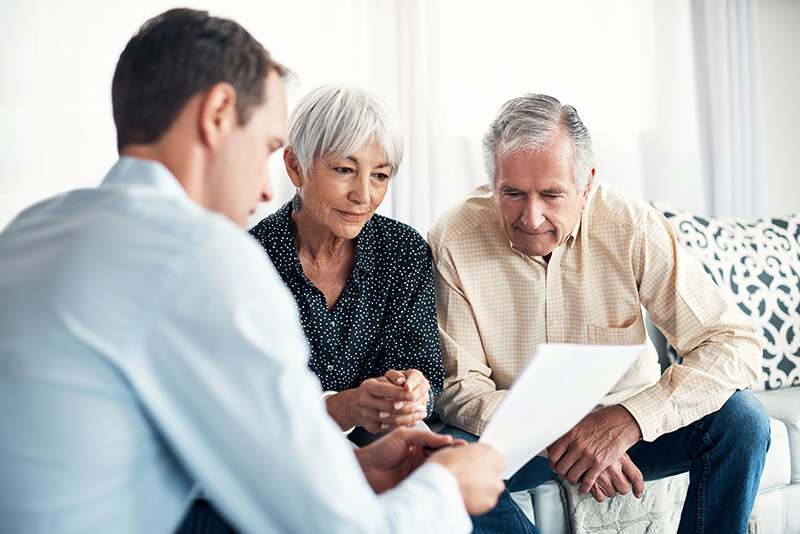 senior couple reviewing financial paperwork at Charter Senior Living of Godfrey